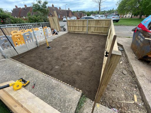 Picture of the front garden with a new fence in places well as the soil on the floor of the garden